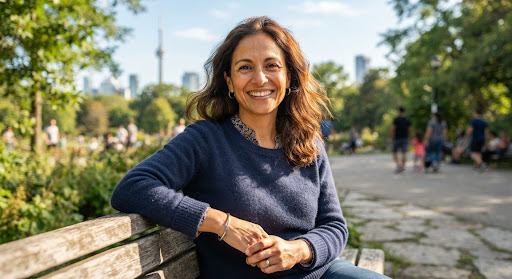 Portrait of Elena, a warm loving 38-year-old mother smiling in a Toronto community park with daylight warmth, confident and grateful.